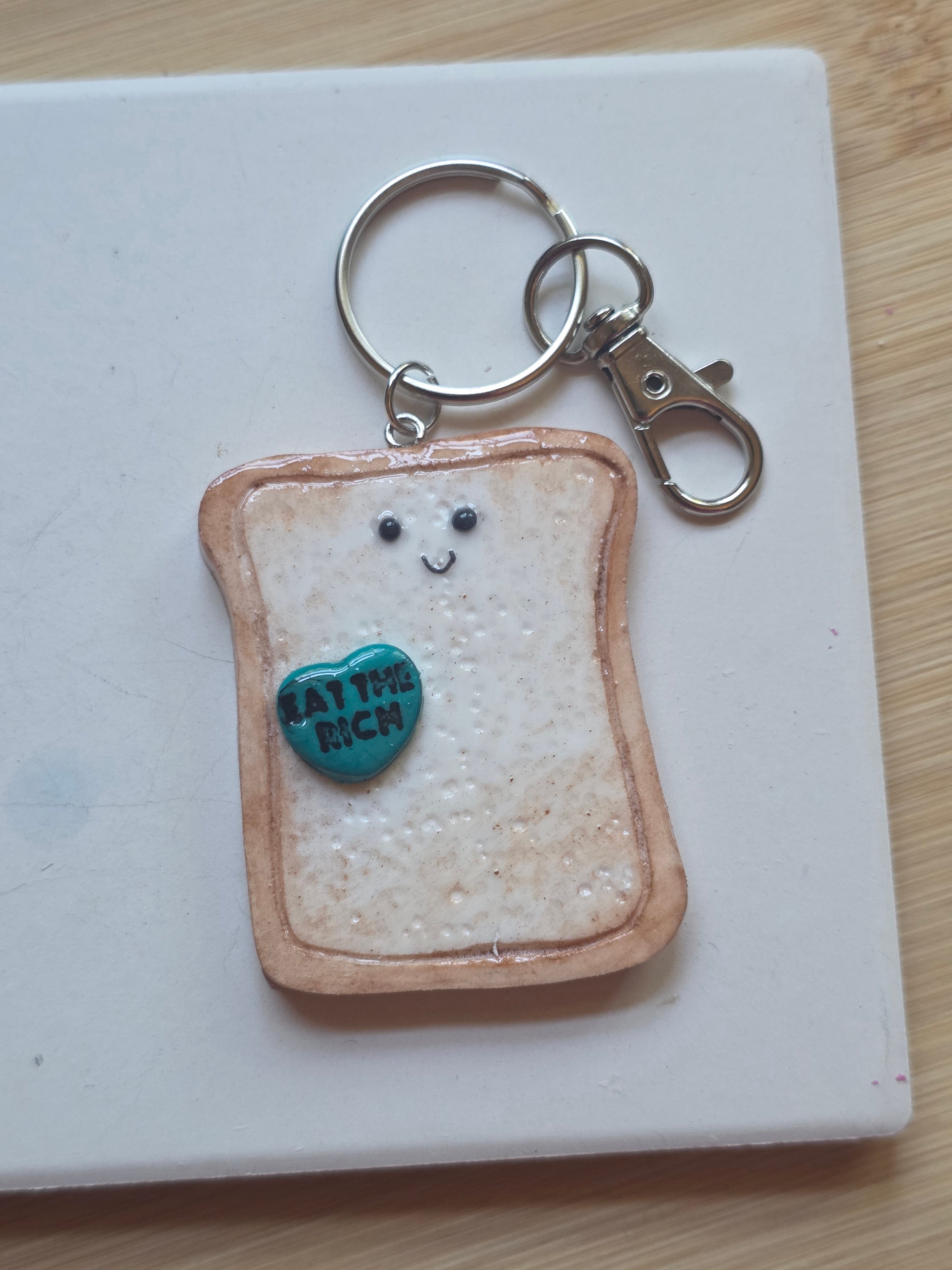 Eat The Rich! Emotional Support Toast Clay Keychain