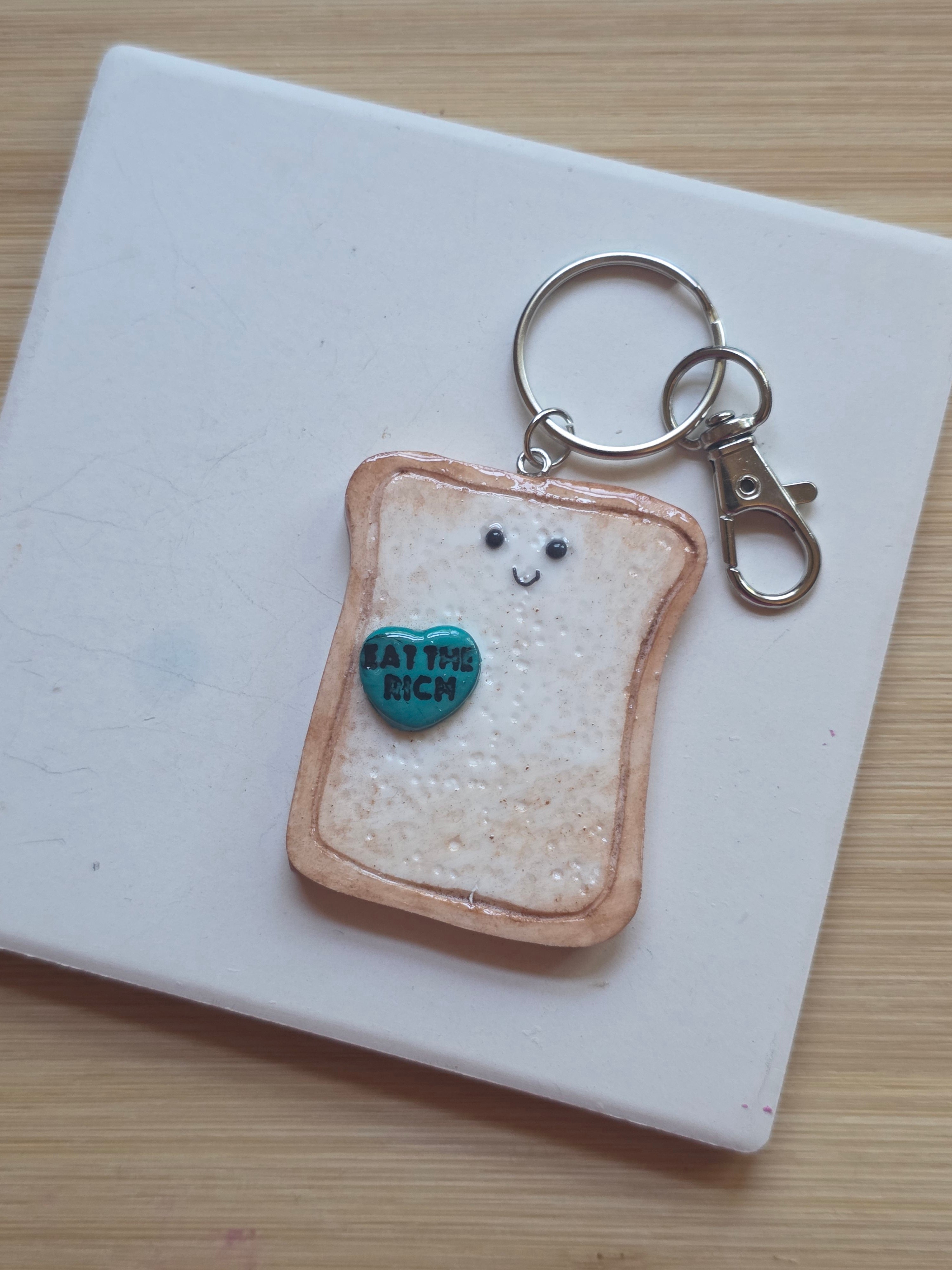 Eat The Rich! Emotional Support Toast Clay Keychain