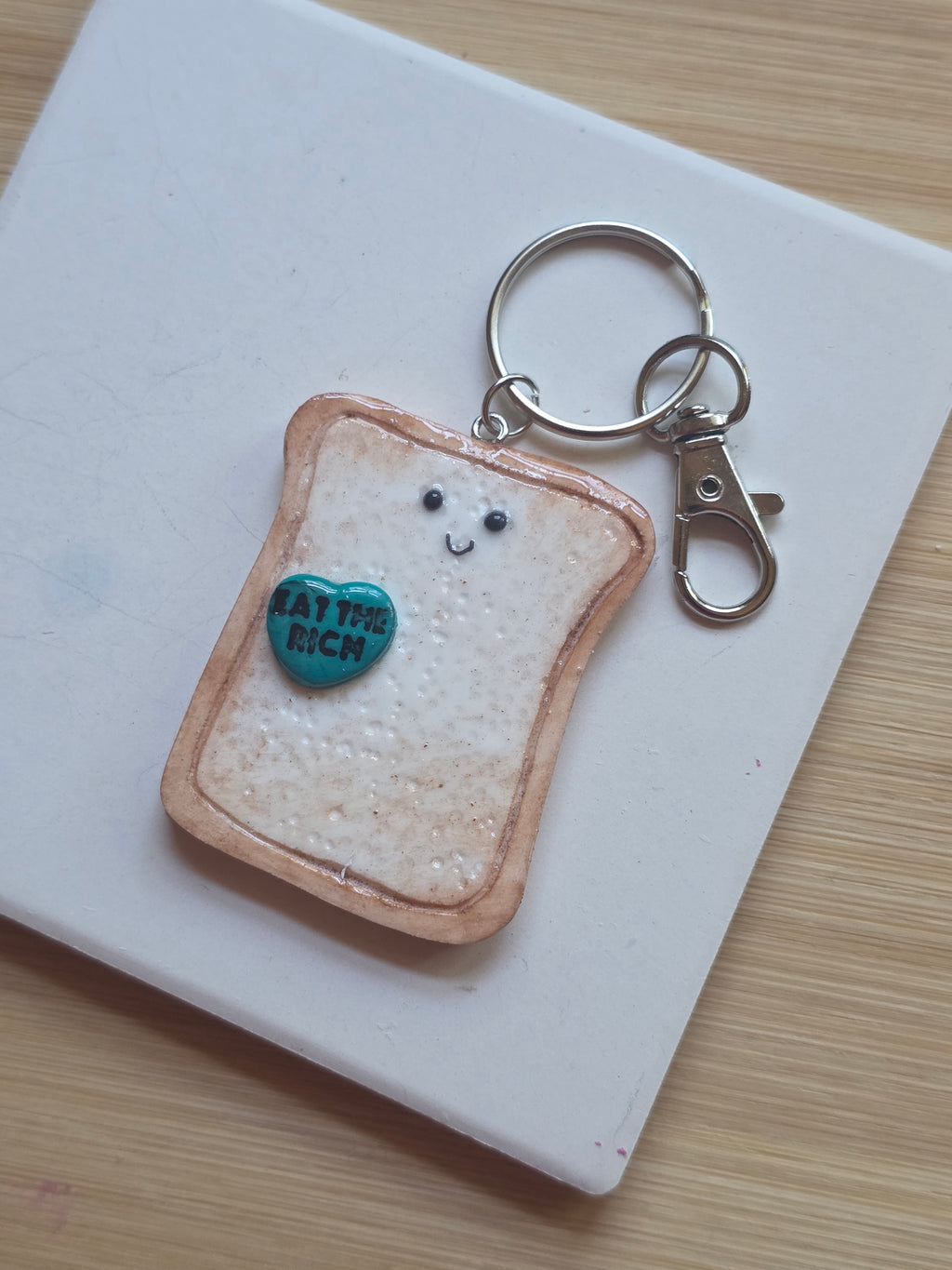 Eat The Rich! Emotional Support Toast Clay Keychain
